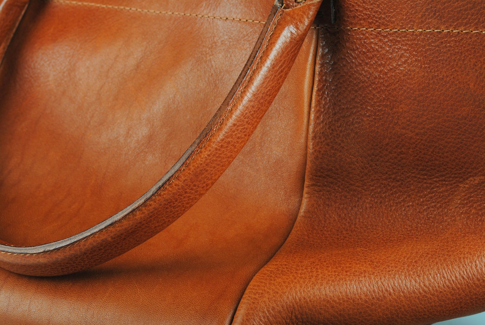 LuxScout app preview showing a leather handbag
